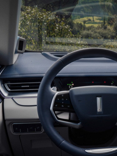 interior shot of a WEY 05 car showing the driver's point of view of the steering wheel and the infotainment display