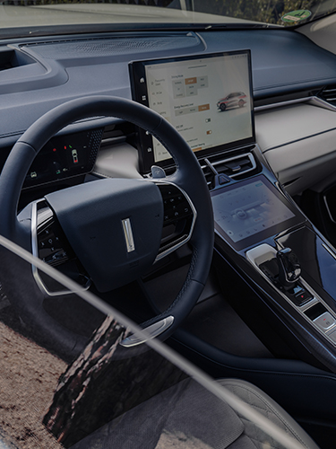 the interior of the WEY 05 car showing the steering wheel and the infotainment display