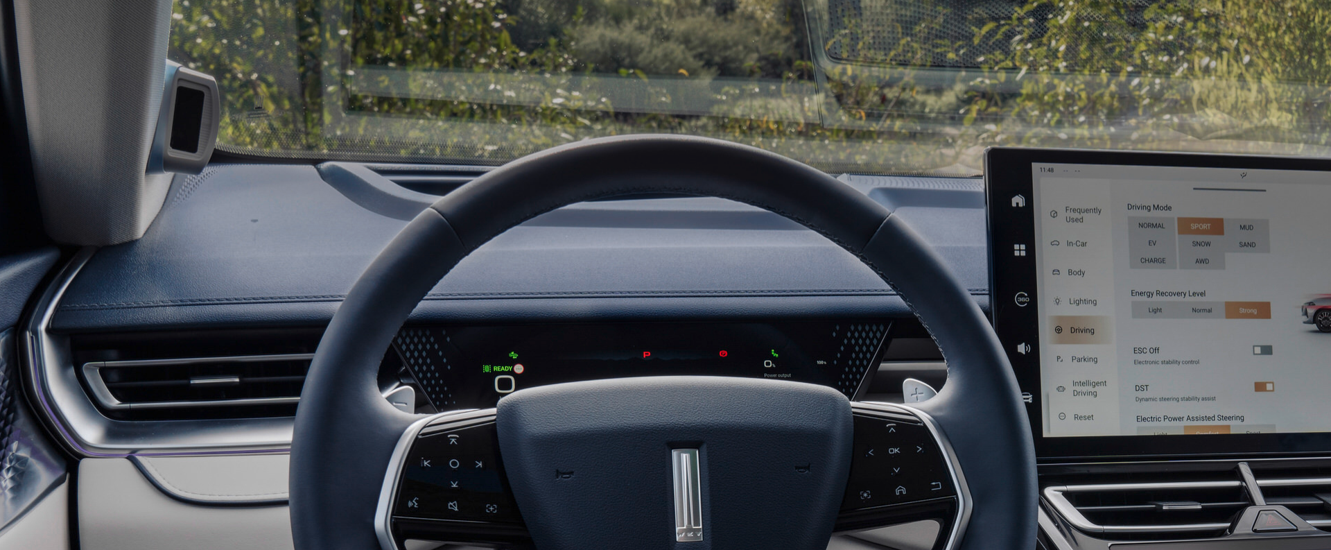 interior shot of a WEY 05 car showing the driver's point of view of the steering wheel and the infotainment display