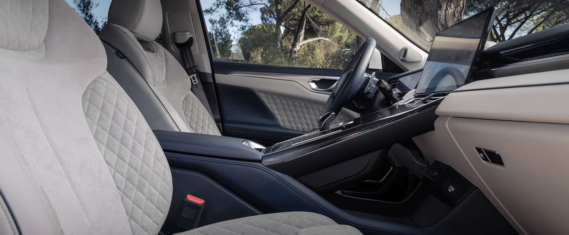 interior of a wey WEY 05 car showing the two white 8-point massage front seats and the armrest in the middle 