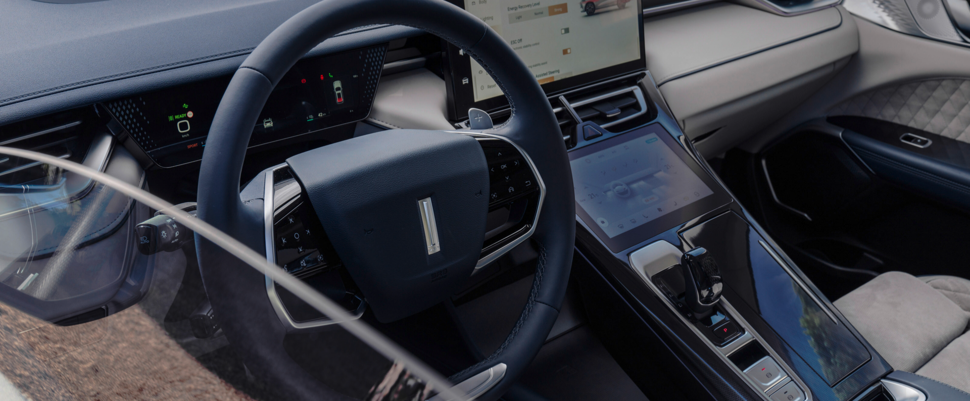 the interior of the WEY 05 car showing the steering wheel and the infotainment display