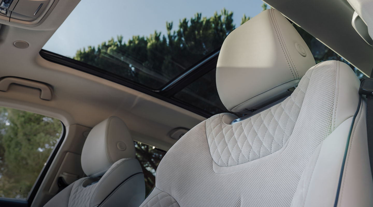 interior shot of the wey coffee 01 car, showing the front headrests and the panoramic sunroof