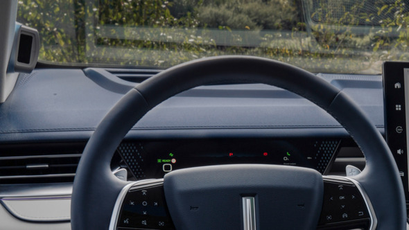 interior shot of a wey 05 car showing the driver's point of view of the steering wheel and the infotainment display