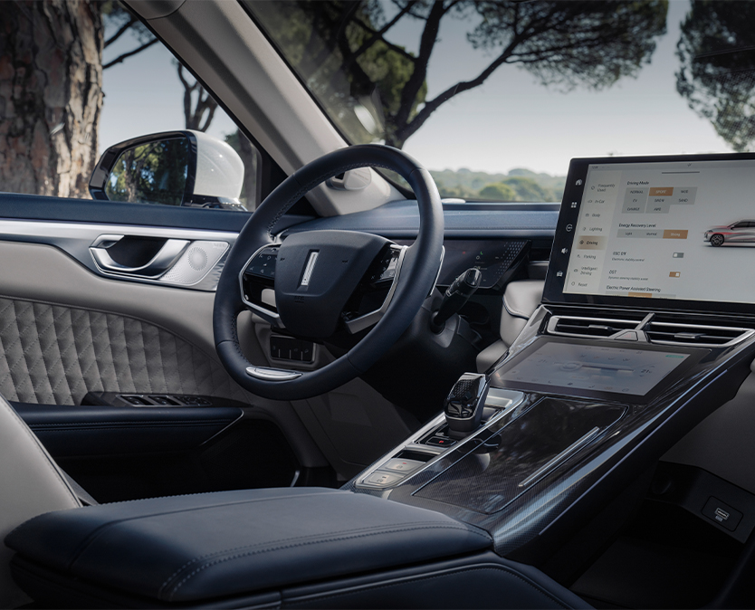 interior shot of a wey 05 car showing  steering wheel and the infotainment display