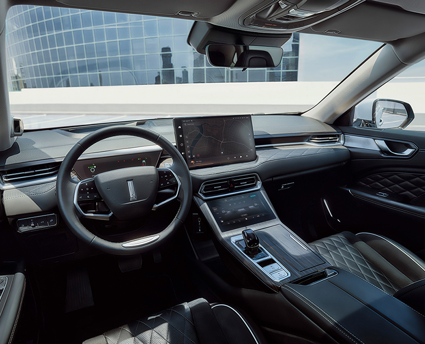 interior shot of a wey coffee 01 car showing  steering wheel and the infotainment display